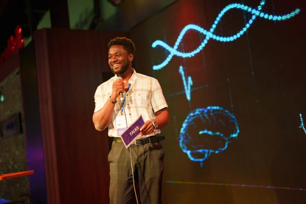 Conference speakers showing presentations on the stage